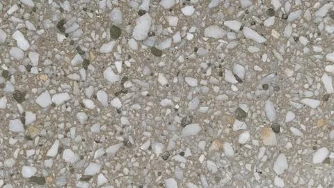 Concrete surface with multi-colored blotches of small stones. Light beige ton 스톡 사진