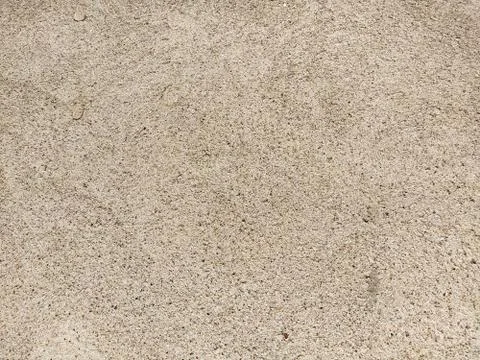 Concrete surface with multi-colored blotches of small stones. Light beige ton Stock Photos