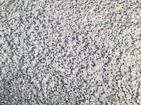 Concrete surface texture with small embedded stones background Stock Photos