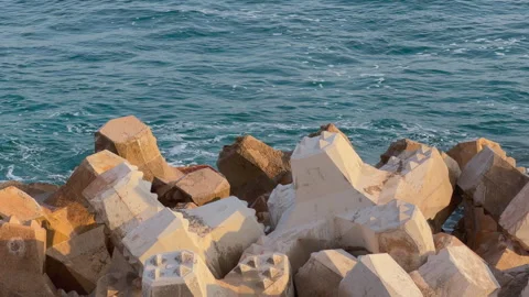 Concrete tetrapod breakwater block by blue sea Vídeo Stock 337404068