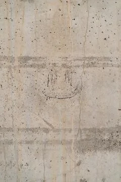 Concrete texture background with a smiley face in the center. vertical photo Stock Photos