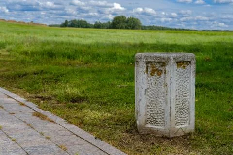 Concrete trash bin by the road overlooking the field. Stock-Fotos