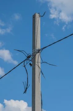 Concrete Utility Pole With Overhead Cables Against Blue Sky Stock Photos