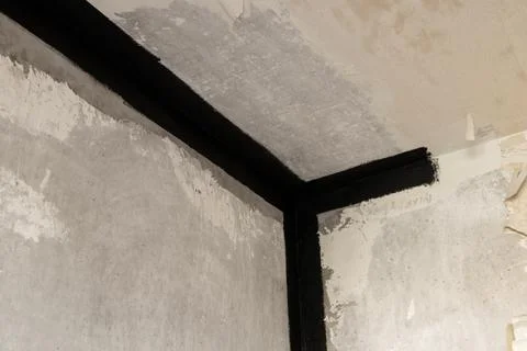 Concrete wall and ceiling in a panel apartment, seams from leaks sealed with Stock Photos