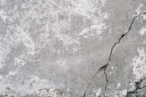 Concrete wall with a deep black gray large crack across the surface Stock Photos