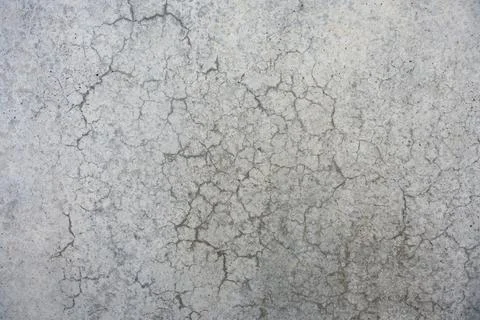 Concrete wall with dense crack network forming a natural abstract pattern. Stock Photos