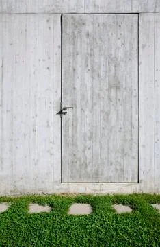 Concrete wall with a door inserted Stock Photos
