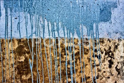 Concrete wall with drips of blue paint Stock Photos