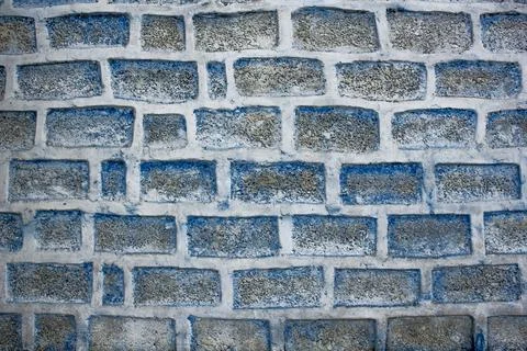 Concrete wall of large blue bricks and white cement. rough surface. rough tex Stock Photos