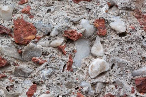 Concrete wall with lining from bits of broken brick. Used as a background. Stock Photos