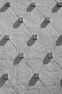 Concrete wall with a relief geometric pattern. Abstract geometric background  Stock Photos