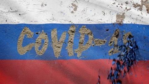 On the concrete wall with the Russian flag appears the inscription: "COVID-19 Stock Footage 128181431