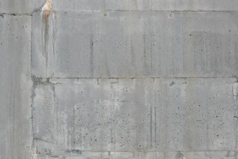Concrete wall shows rough texture with visible patches and stains in urban area 스톡 사진