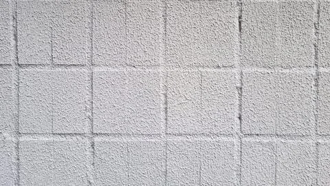Concrete wall surface with square tile pattern and rough textured white Stock Photos