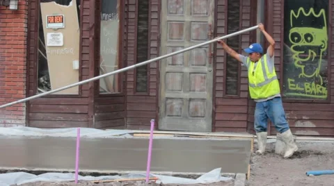 Concrete Worker Finishing Concrete by Pulling a Bullfloat Stock Footage 40538913