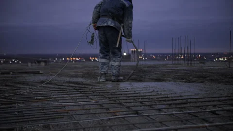 Concrete Worker Vibrating Slab After Pouring at Construction Site Stock Footage 327871384