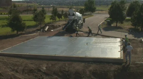 Concrete workers put fininshing touches on newly poured floor. Stock Footage