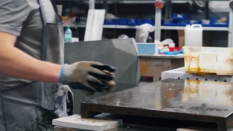 Concrete workshop - a man wiping the surface n workshop with a special solution Stock Footage 127075899