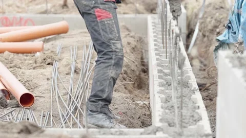 Concreting from the pipe of the foundation of the building from the lost Stock Footage 235662906