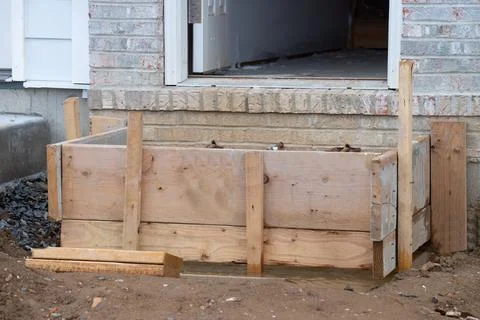 Concreting steps using homemade formwork material building Stock Photos