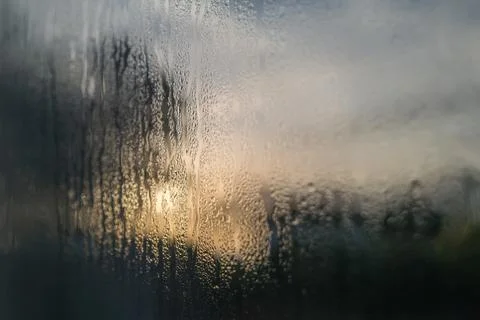 Condensation on the outside of double glazed window glass at sunrise Stock Photos
