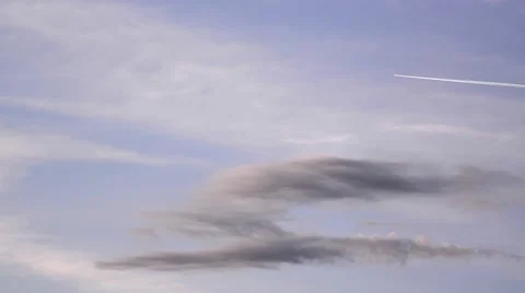 Condensation trails left behind planes passing through the morning sky dotted Stock Footage 60798816