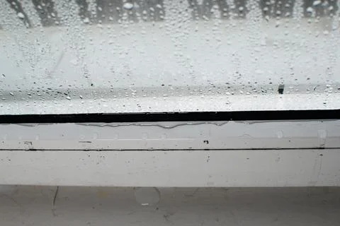 Condensation on the window, drops running down the glass Stock Photos