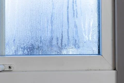Condensation on the window inside the house. Stock Photos