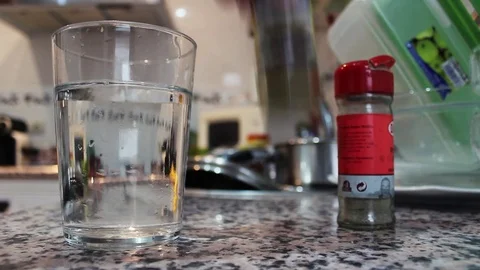 Condiments pour into a glass of water Stock Footage 71363593