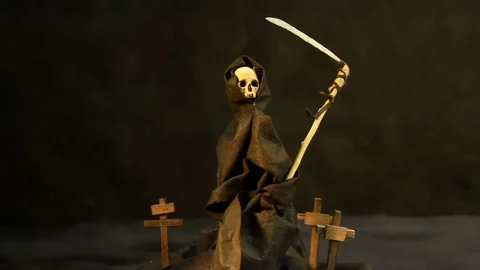 Conditional symbol of death in dark mantle with a hood on dark background fog Stock Footage 121884704
