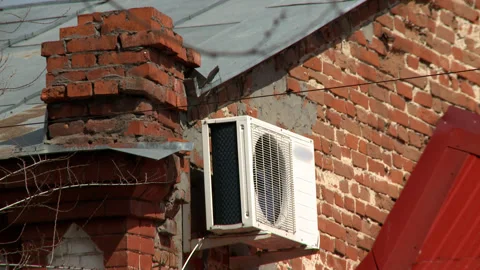 Conditioner fixed on the wall of old house Stock Footage 142722540
