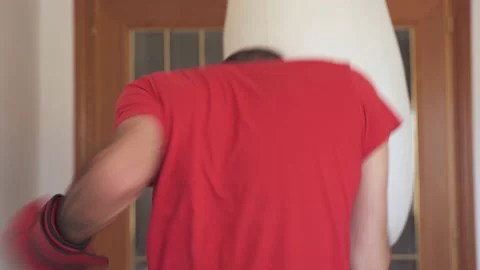 Conditioning boxing training at home. Young male throws punches in living room Stock Footage 195348468