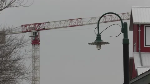 Condo construction crane rises behind old train station Vídeo Stock 151727001