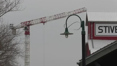 Condo construction crane rises behind old train station Vídeos de archivo 151727208