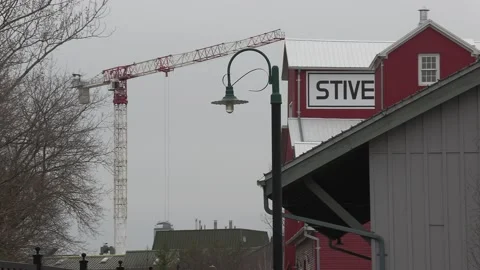 Condo construction crane rises behind old train station Vídeo Stock 151727250