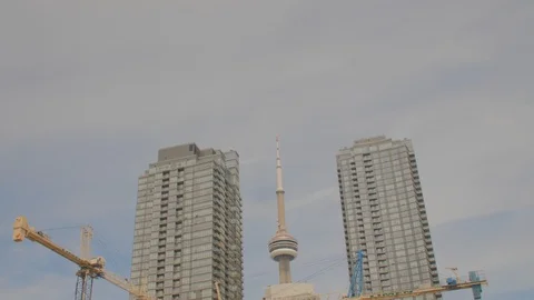 Condo Construction Development Building Tower Cranes CN Tower Pan Down Stock Footage 92319537