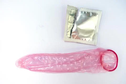 Condom is available on white background. Stock Photos