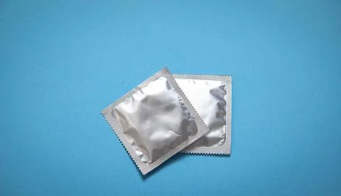Condom on the blue background. Stock Photos