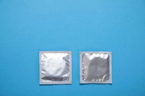 Condom on the blue background. Stock Photos