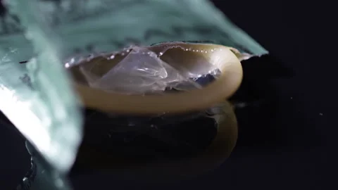 Condom close up prophylactic for pregnancy prevention and STI protection. Stock Footage 254021157