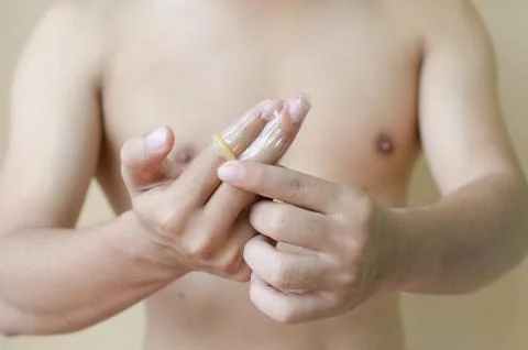 Condom on the finger Stock Photos