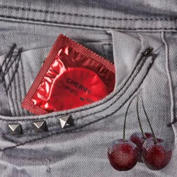 Condom in the grey jeans Stock Photos