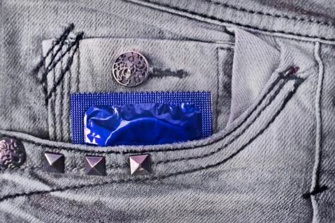 Condom in the grey jeans Stock Photos