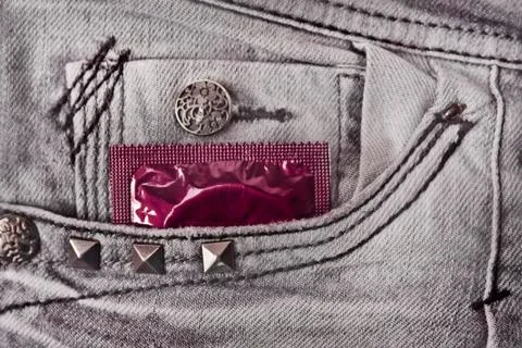 Condom in the grey jeans Stock Photos