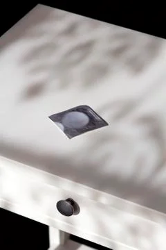 Condom on a night table Stock Photos