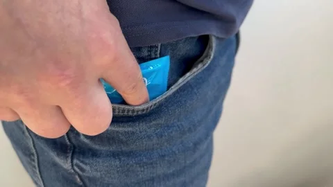 Condom in pants pocket Stock Footage 244814359