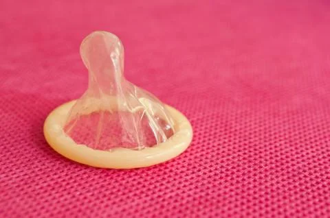 Condom on pink background Stock Photos