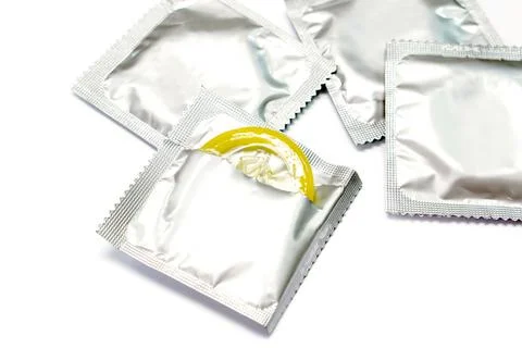Condom in seal package and opened isolate on white background. Stock Photos