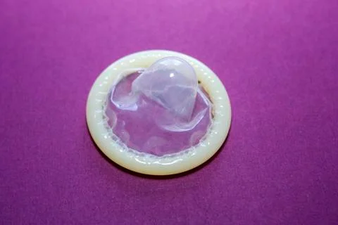 A condom on a violet background Stock Photos
