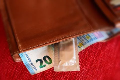 Condoms and banknotes in the leather wallet 스톡 사진